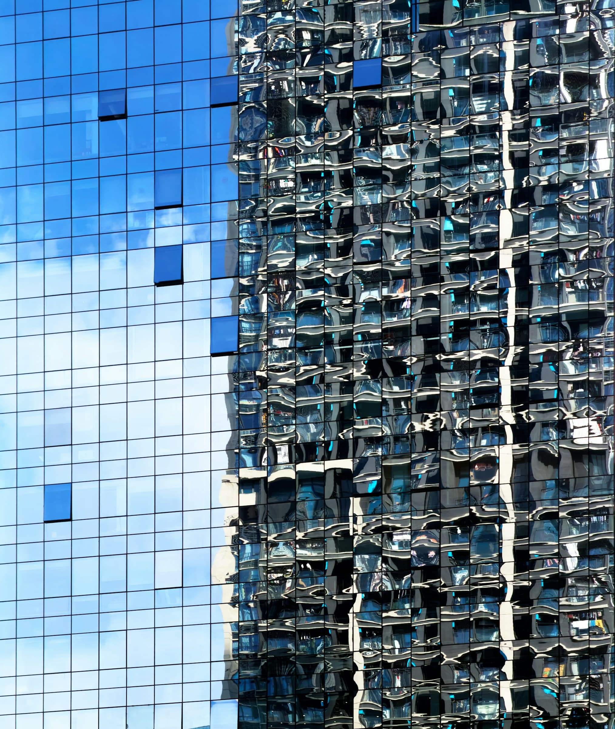 Blaue Glasfassade mit Spiegelungen